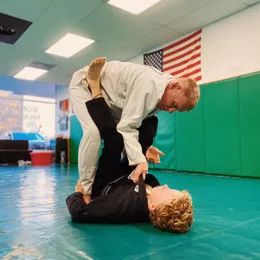 Professor James Boran demonstrating a technique on a student during an adult class
