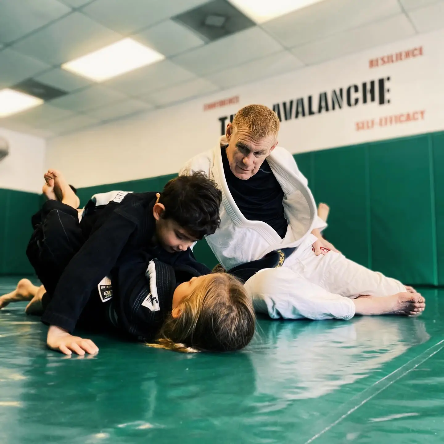 Professor James Boran teaching a kids' Brazilian Jiu-Jitsu class on the mat at Boran Brazilian Jiu-Jitsu in Costa Mesa